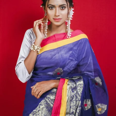 Woman in a blue silk saree with a yellow border
