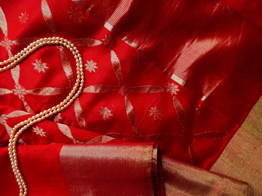 Red silk saree fabric with pearl jewellery
