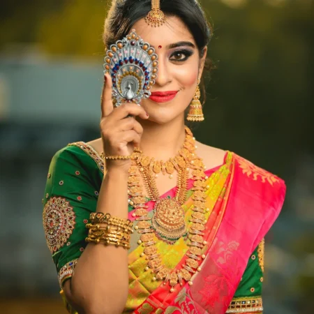 Woman in a pink silk saree with a green blouse
