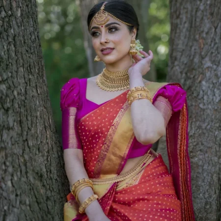Woman in a pink and orange Kanchipuram silk saree