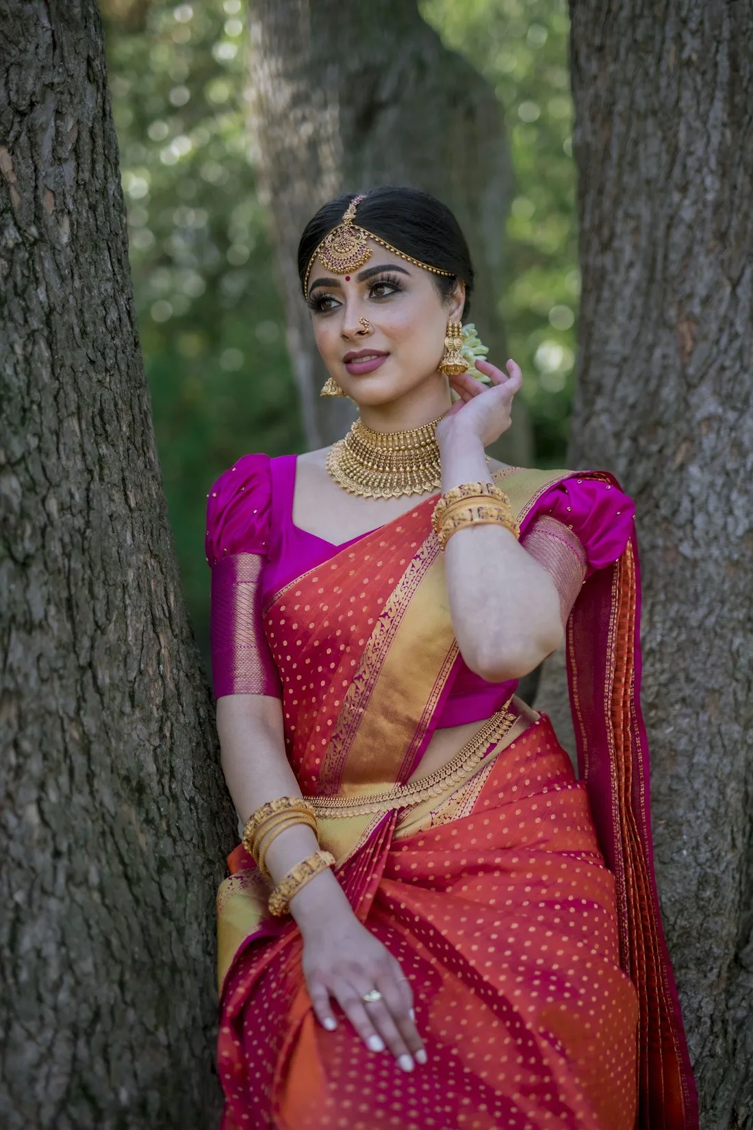 Woman in a pink and orange Kanchipuram silk saree