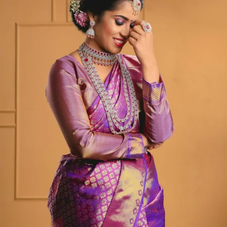 Woman in a purple and gold silk saree with jasmine